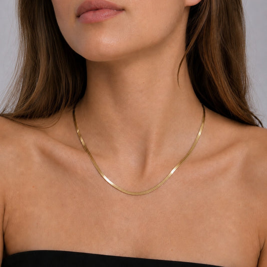 Model wearing a 14ct gold vermeil snake chain necklace.