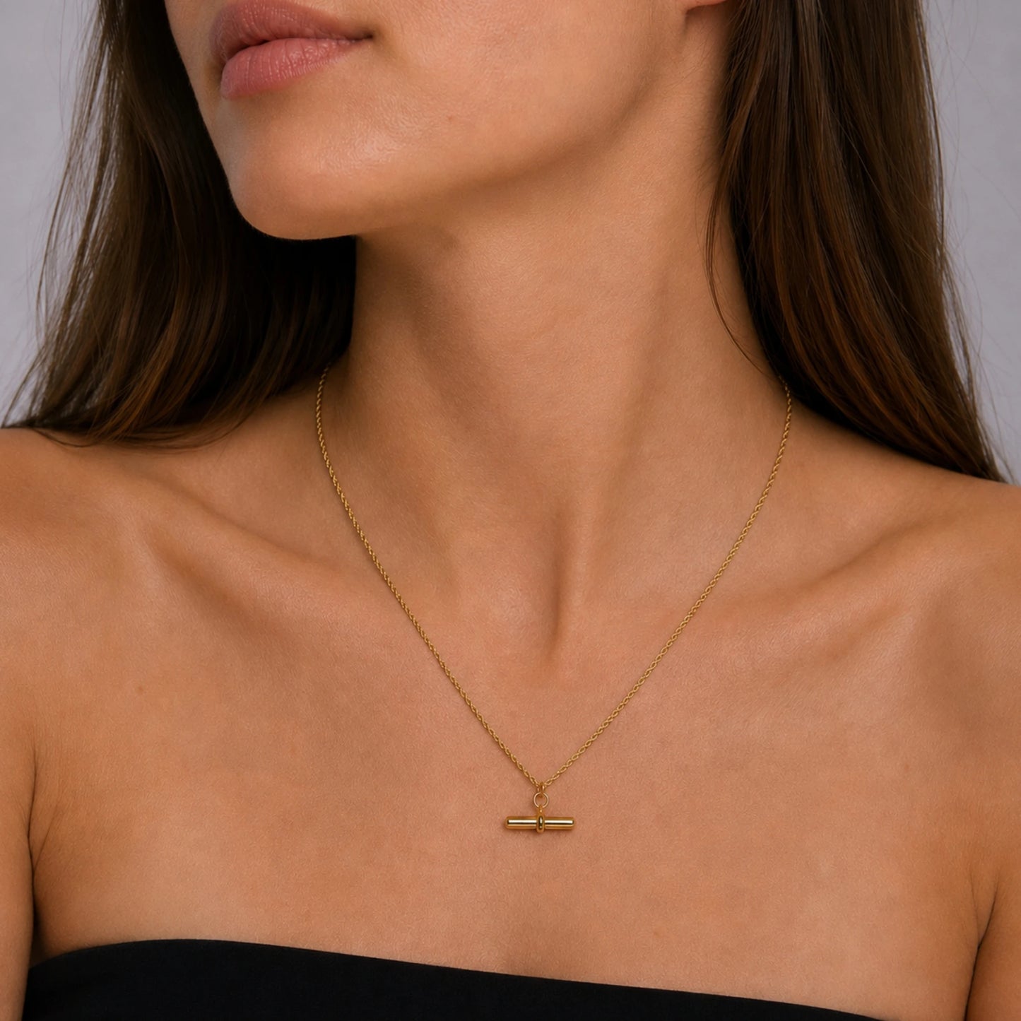 Model wearing a 14ct gold vermeil T-bar pendant necklace.