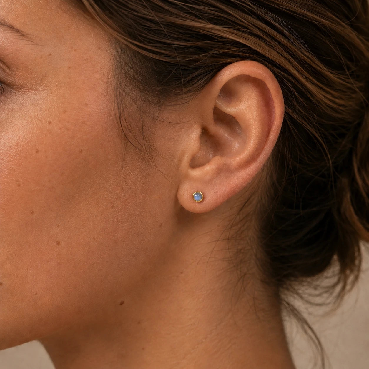 Model wearing 14ct gold vermeil labradorite stud earrings, 4mm minimalist gemstone earrings for everyday wear.