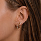 Model wearing 14ct gold vermeil rainbow moonstone hoop earrings and marquise stud earrings.