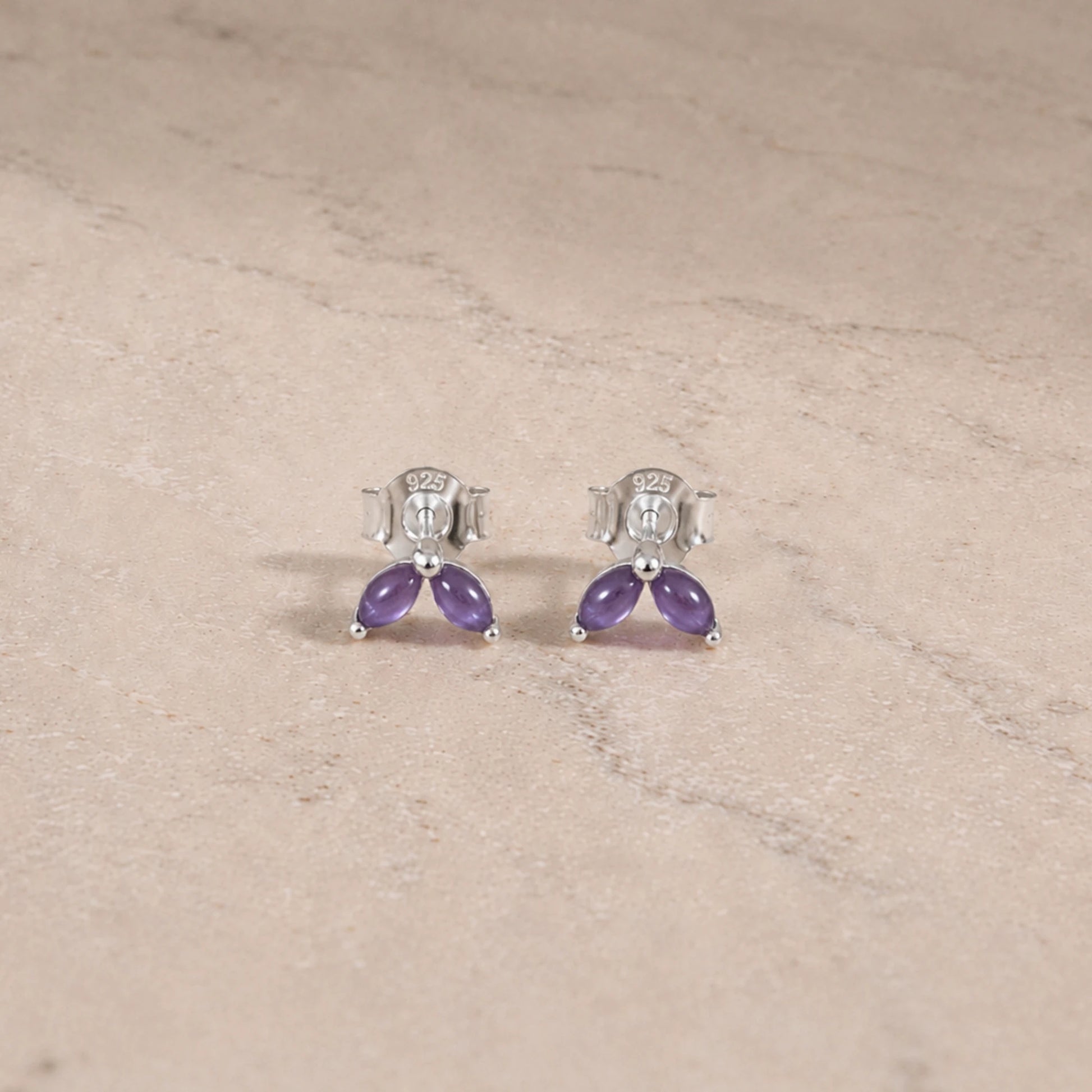 Sterling silver amethyst marquise stud earrings with smooth cabochon gemstones.