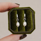 Sterling silver baroque pearl huggie earrings displayed in a green velvet jewellery box with removable freshwater pearl charms.