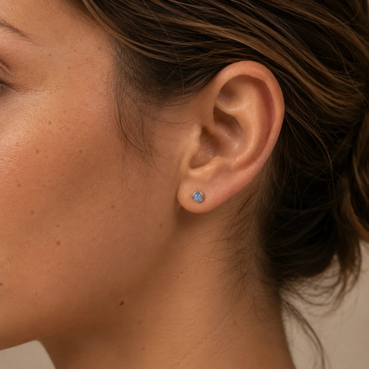 Model wearing sterling silver labradorite stud earrings, 4mm minimalist gemstone earrings for everyday wear.