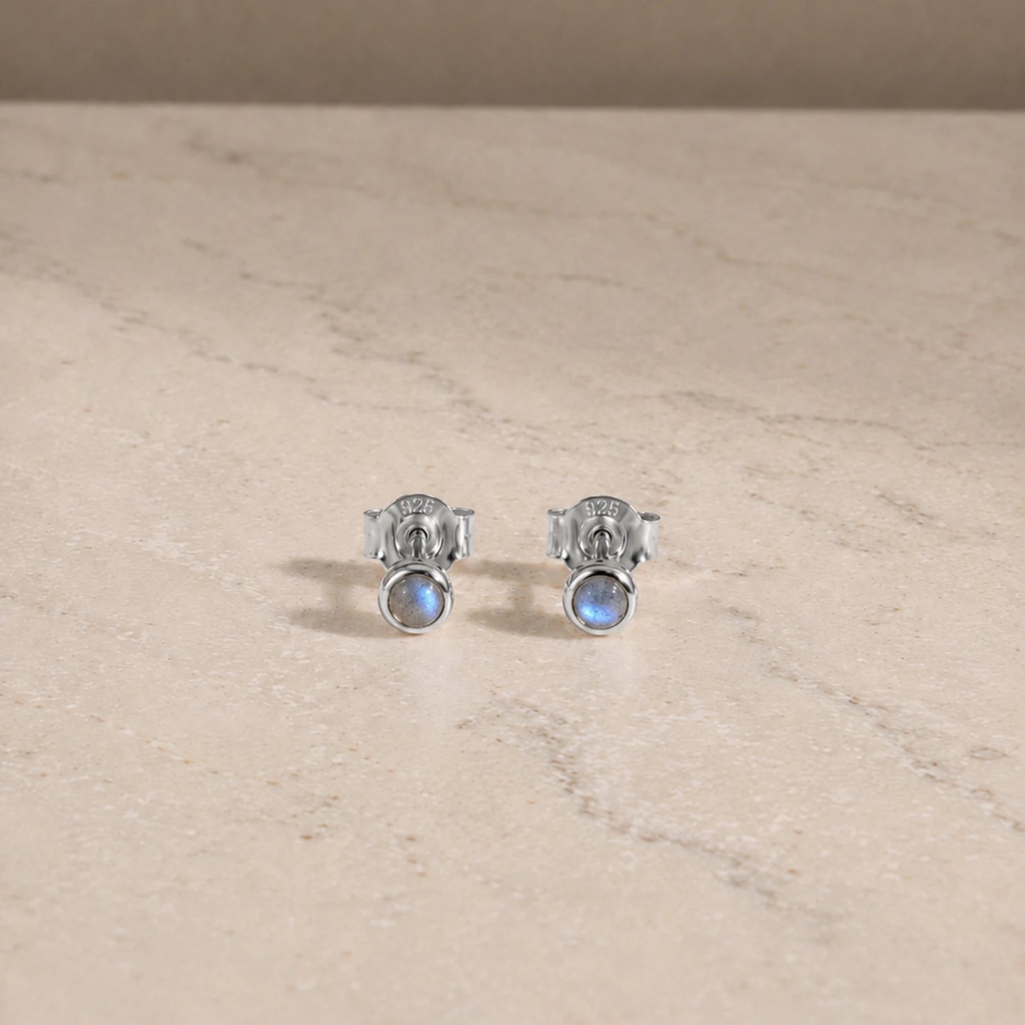 Sterling silver labradorite stud earrings with round cabochon gemstones.