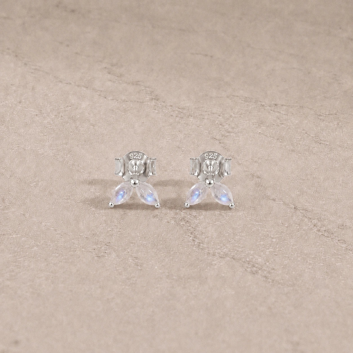 Sterling silver rainbow moonstone marquise stud earrings with smooth cabochon gemstones.