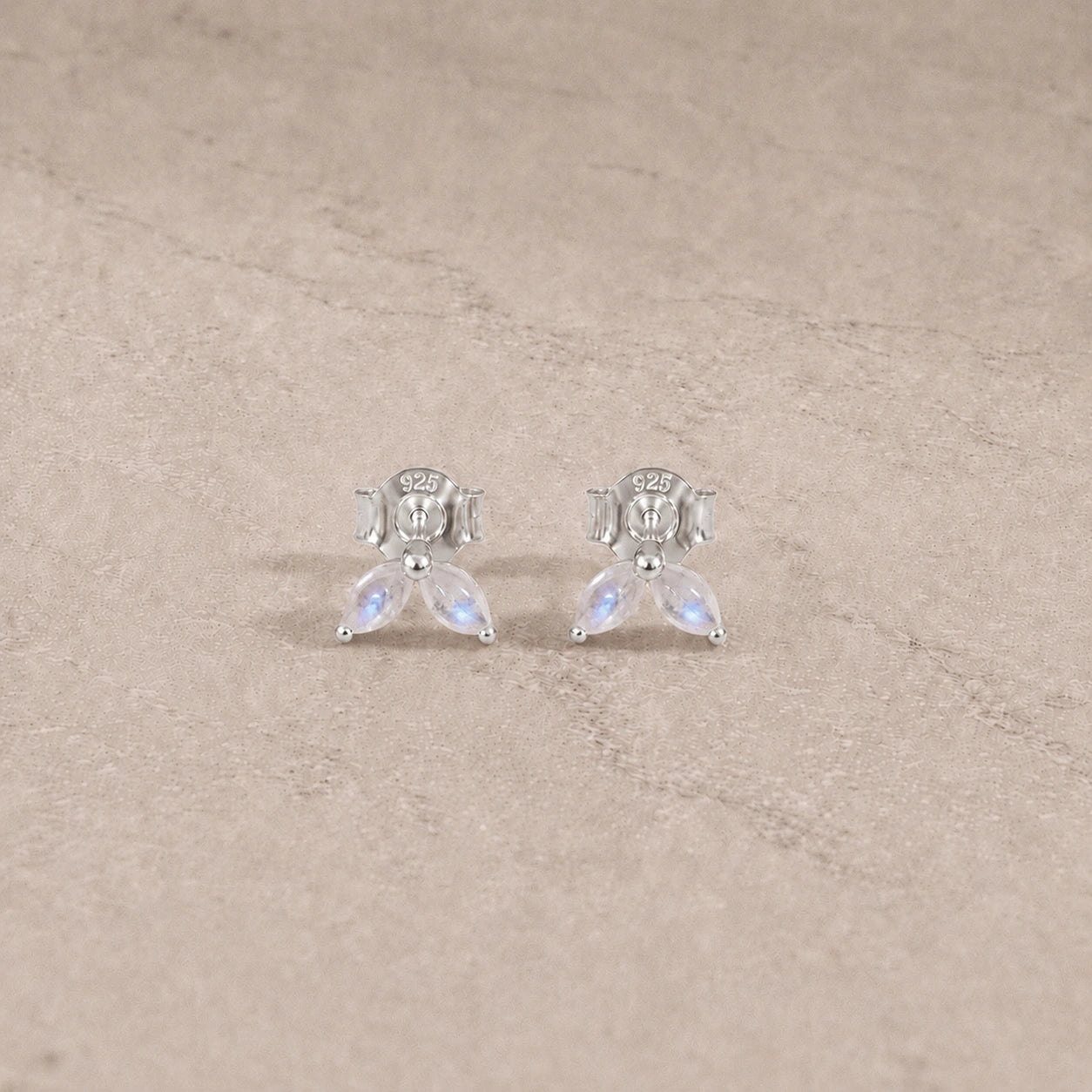 Sterling silver rainbow moonstone marquise stud earrings with smooth cabochon gemstones.