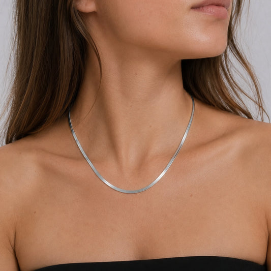Model wearing a sterling silver snake chain necklace.